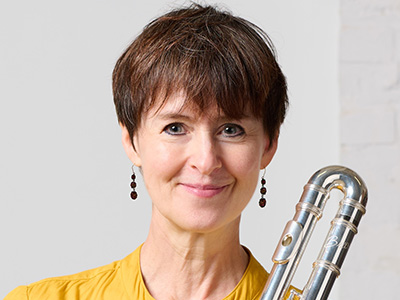 Patricia Julien in a yellow dress with an alto flute